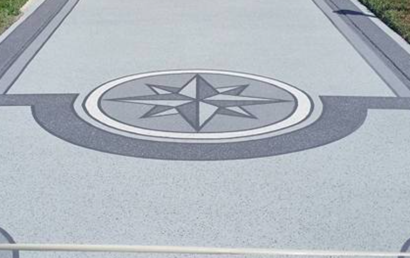 Decorative compass design in a coated driveway